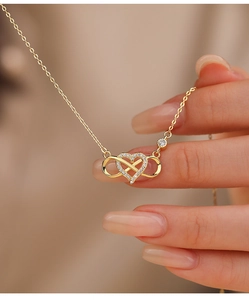 Detailed macro view of heart and infinity pendant necklace with white zircons