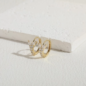 Macro detail of 14K gold plated butterfly earrings with sparkling cubic zirconia crystals