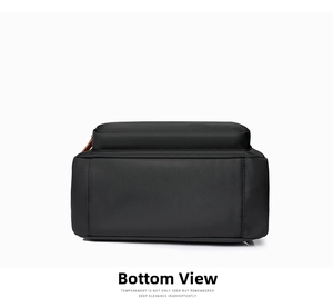 Detailed bottom view of the black nylon backpack showing neat stitching and orange zipper accents