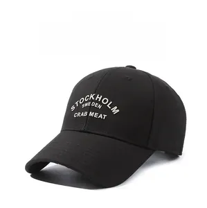 Close-up of Stockholm Sweden embroidery on a black cotton baseball cap with fine texture