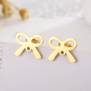 Elegant gold hollow bowknot stud earrings in titanium steel displayed on a card