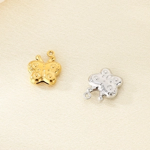 Detailed view of hollow 3D butterfly pendants in gold and silver finish with small top rings