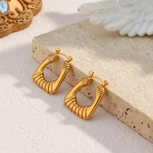 Detail shot of vintage 18k gold plated square hoop earrings with spiral texture pattern