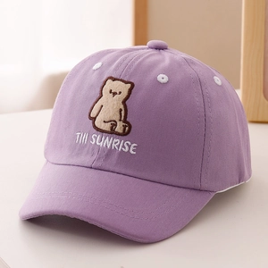 Detailed close-up of bear embroidery and cotton twill texture on kids purple baseball cap