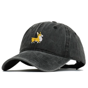 Detailed view of yellow Corgi dog embroidery on washed cotton baseball cap