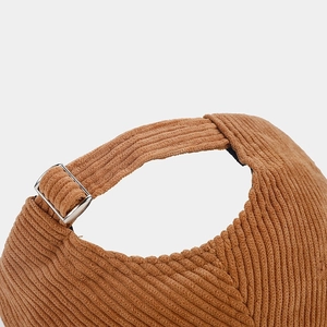 Close-up of brown corduroy baseball cap with adjustable metal buckle back strap