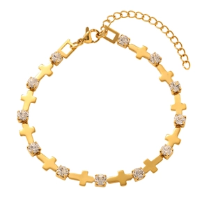 Detail of gold cross bracelet featuring white crystal stones and adjustable chain clasp