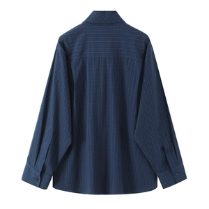 Detail view of the back of a navy blue plaid cotton shirt with yellow checkered pattern
