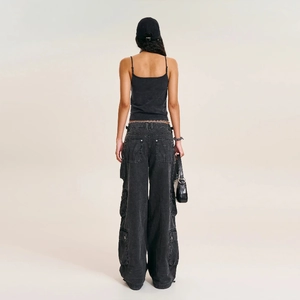 Back view of a black camisole top and dark grey wide-leg cargo pants for women