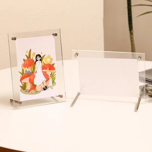 Double-sided clear acrylic photo frame set with metal supports for tabletop display