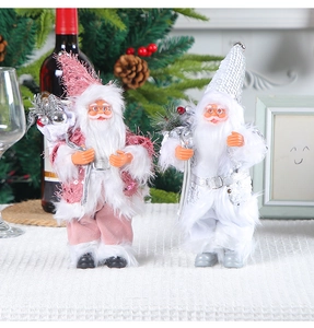 Close-up of pink and silver sequined Santa Claus figurines on a festive tabletop