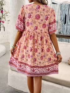 Detailed back view of a pink floral boho dress with Mediterranean holiday print