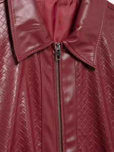 Close-up of woven wine red faux leather jacket featuring metal zipper and lapel detail