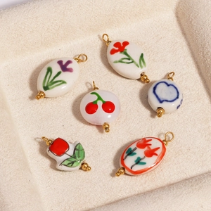 Ceramic pendants with floral, cherry, and heart prints in gold-plated 18K settings