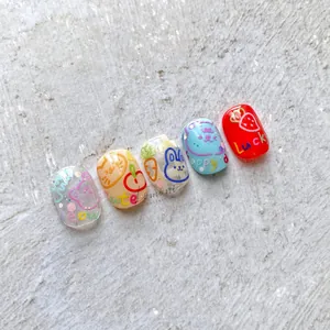 Detail of cute hand-drawn cartoon bear and rabbit patterns on polished nail art tips
