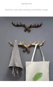 Detailed close-up of vintage resin antler wall hooks with realistic hand-carved textures