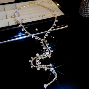 Detailed close-up of a luxury long tassel necklace with shimmering crystals and gold plating
