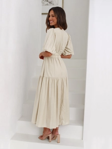 Detail showing high-waist elastic band and textured fabric of the tiered maxi dress