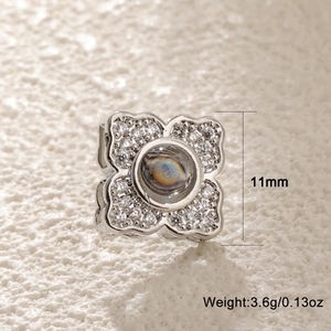 Macro detail of silver clover pendant with 11mm size and 3.6g weight markings