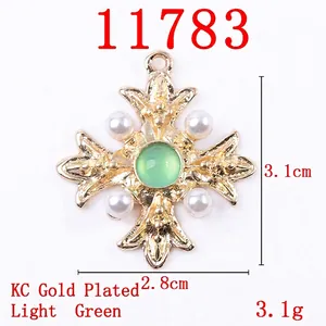 Alloy cross pendant with light green crystal and white pearls in KC gold finish