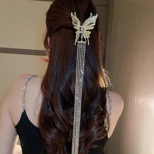 Pince à cheveux papillon dorée élégante avec de longs glands en strass brillants