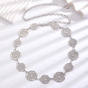 Detail of bohemian silver belt with hollow mandala discs and adjustable link chain