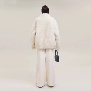 Back view of a white faux fur coat and matching wide-leg pants for a stylish winter look
