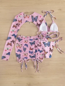 Flat lay of pink four-piece bikini set with butterfly print and mesh cover-up