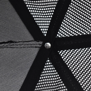 Macro detail of breathable trucker hat interior with black mesh and silver metal fastener