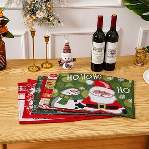 Detailed view of woven Christmas placemats with Santa Claus and snowman patterns