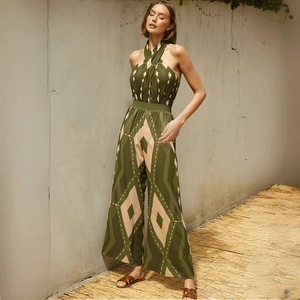 Deep green geometric print halter neck jumpsuit with wide leg design for beach vacations