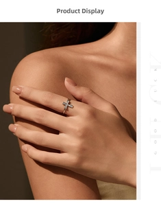 Close-up of elegant gold cross ring with pavé moissanite worn on a model's hand