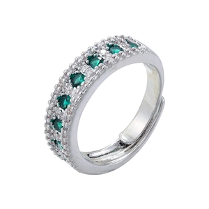 Macro detail of silver open ring featuring green gemstones and clear zircon accents
