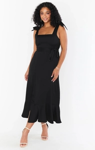 Detail of square neck sleeveless black midi dress with ribbon straps and ruffled hemline