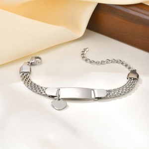 Detail of silver mesh steel bracelet with blank rectangle plate and heart charm