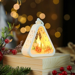 Detail of a white Christmas lantern with warm LED light and Santa Claus deer scene