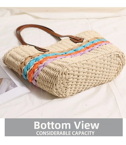 Detail view of the colorful rainbow stripes and wide bottom of the straw beach tote bag