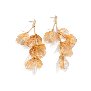 Detail view of gold layered gingko leaf earrings with white teardrop pearl tassels