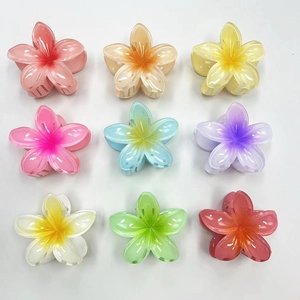 Macro view of gradient frangipani hair claws in nine candy colors for hair styling
