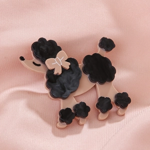 Elegant acrylic poodle brooch with black wavy fur details on pink satin background