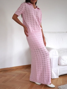 Detail of pink knitted two-piece set featuring hollow-out wave texture and polo collar