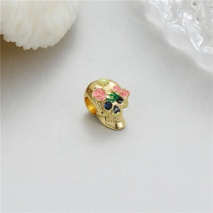 Gilded skull bead with pink roses and colorful gemstones for DIY jewelry crafts