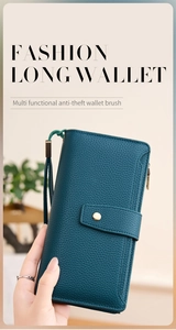 Detail of dark green textured leather long wallet with wrist strap and RFID blocking feature