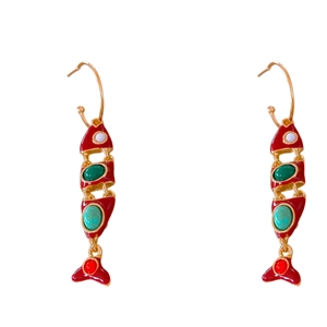 Vintage gold fish earrings with red enamel and colorful gemstones on white background
