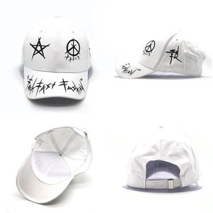 White hip hop baseball cap with black graffiti print and metal ring details shown in four angles