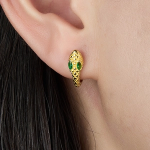 S925 silver gold snake hoop earrings with green zircon eyes shown on a female model