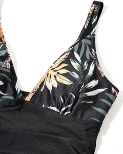 Close-up of tropical floral pattern on swimsuit with sexy black mesh details