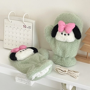 Close-up of plush light green mittens with cartoon puppy design and hanging string