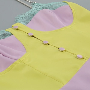 Detail of lace trim and gold chain straps on a sexy white split maxi dress