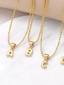 Detail of gold-plated letter A B C D pendants with polished beads chain for women